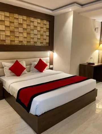 Deluxe room at 8fold by LaRiSa Basti showing a larger sleeping area, seating corner, and warm interior tones