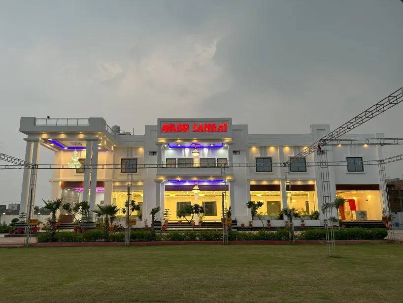 Entrance view of Avadh Samrat Resort Ayodhya with driveway, exterior façade, and signage