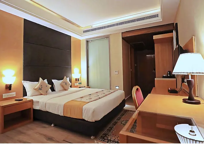 Deluxe room at Bindiram By ShriGo Hotels Chitrakoot with additional seating space and neatly arranged interiors