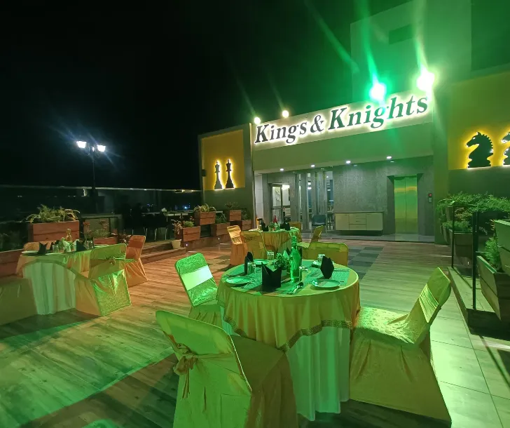 Restaurant interior at Clarks Inn Express Udaipur with arranged dining tables and chair layout