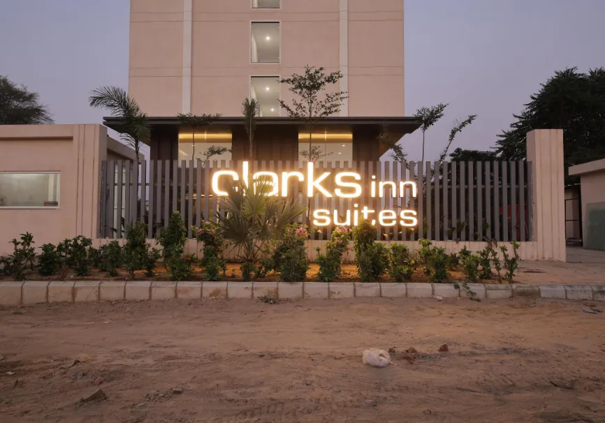 Hotel entrance of ClarksInn Suites Jaipur with exterior façade and driveway access