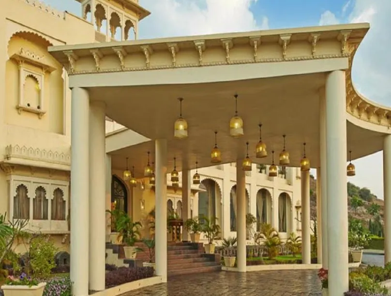 Entrance of Club Mahindra Resort Udaipur with exterior façade and entrance pathway
