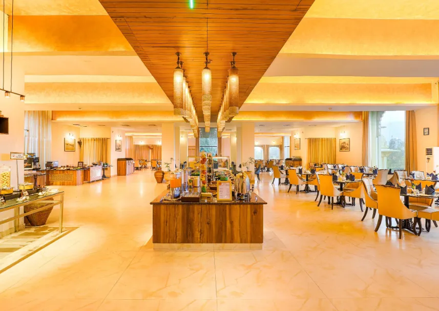Restaurant at Club Mahindra Resort Udaipur with dining tables and relaxed interior setting