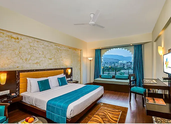 Superior room at Club Mahindra Resort Udaipur featuring organized furniture and soft lighting