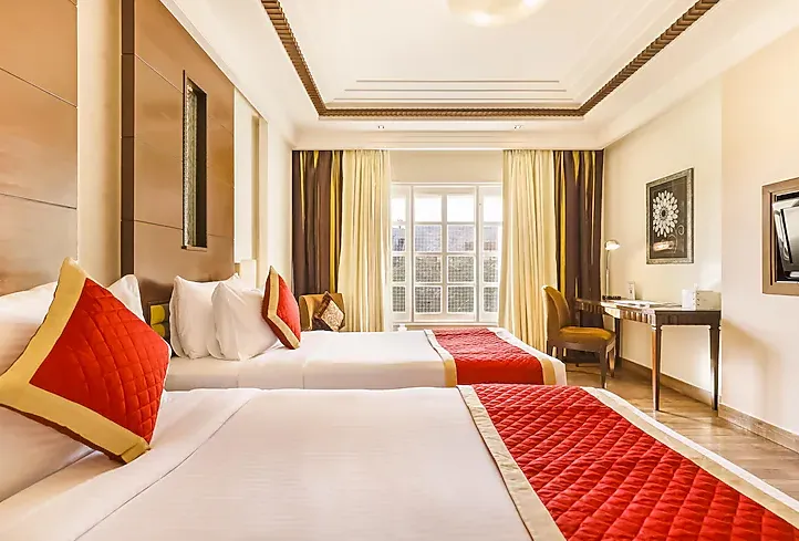 Superior room at Club Mahindra Jaipur with bed, side tables, and gentle lighting