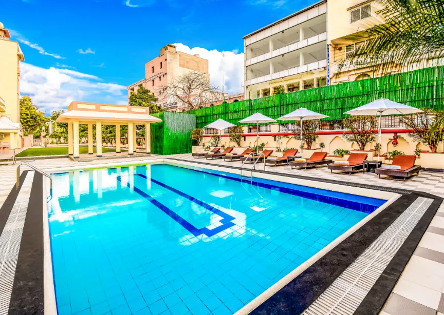 Swimming pool at Club Mahindra Jaipur with clear water and poolside seating