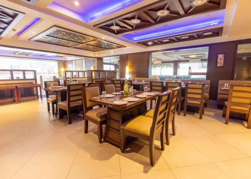 Restaurant at Crestmont Ashapurna Jaipur with dining tables and ambient interior lighting