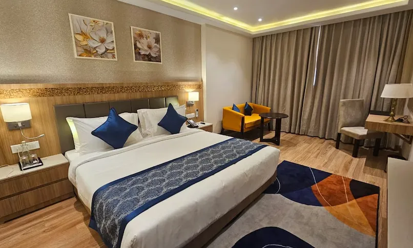 Suite room at Cygnett Inn Airport Jaipur with extended living space and furniture layout