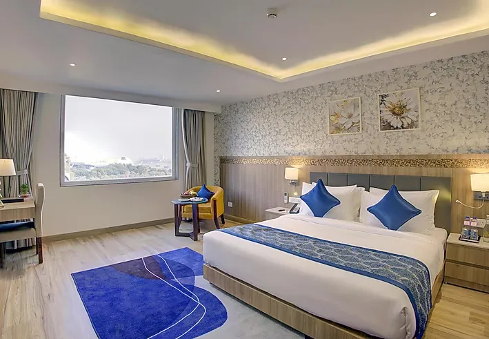 Superior room at Cygnett Inn Airport Jaipur with bed setup and natural lighting