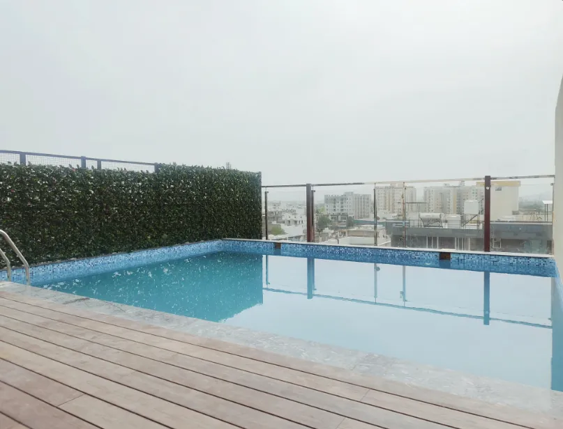 Swimming pool at Cygnett Style Ganga Jaipur with clear water and poolside seating