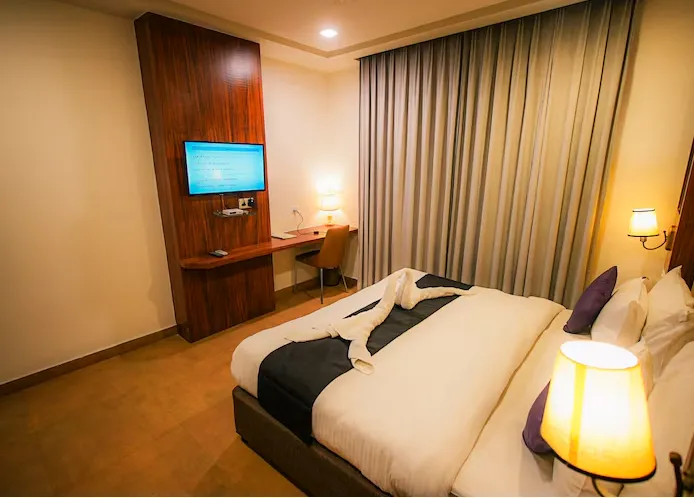 Restaurant at Dazzling Hotel and Resorts Agra with dining tables, chairs, and ambient lighting