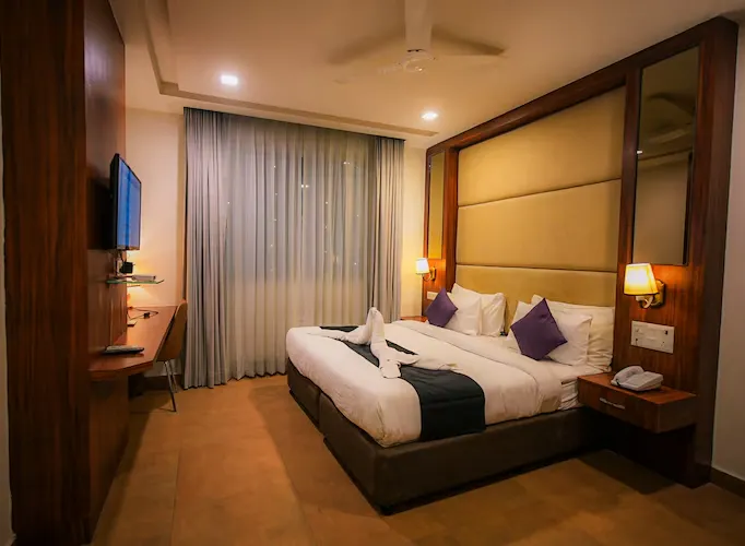 Deluxe room at Dazzling Hotel and Resorts Agra with added seating space and wider room layout