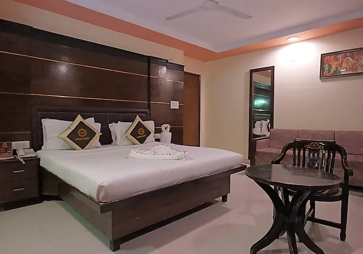 Deluxe room at Foxoso Taj View Agra showing larger layout, seating space, and window lighting