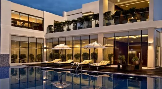 Swimming pool at Golden Tulip Lucknow with clear water and surrounding deck area