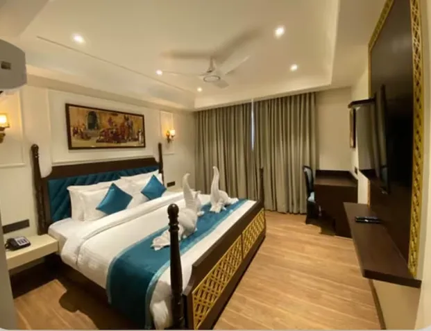 Deluxe room at Heena Heritage Resort Jaipur with wider layout, seating area, and soft lighting