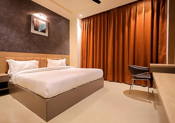 Deluxe room at Hotel Aryavilas Mathura showing spacious layout and upgraded furnishings