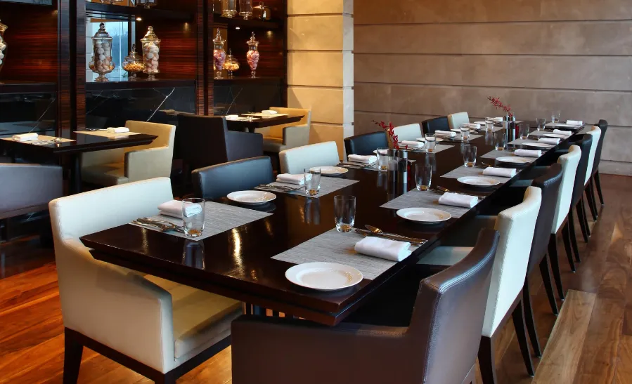 Restaurant at Hotel Neelkanth Ayodhya with dining tables and indoor meal arrangement