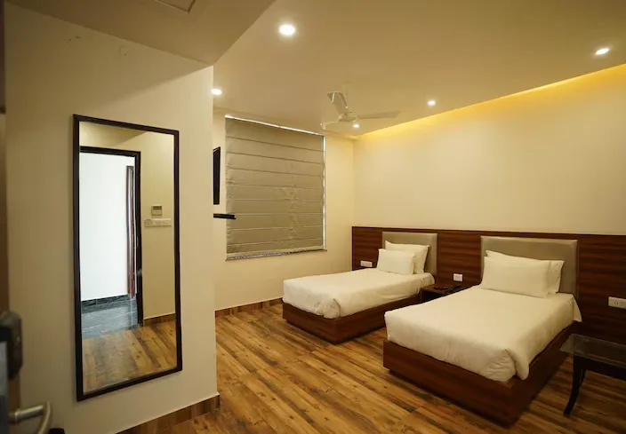 Deluxe room at Hotel Regal Jaipur with double bed setup and neatly arranged furniture