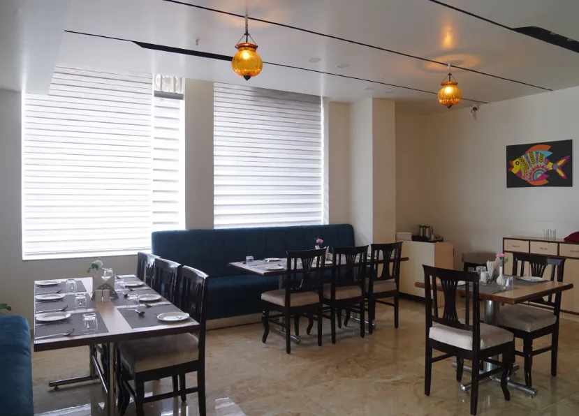 Restaurant at Hotel Regal Jaipur displaying dining tables and interior seating arrangement