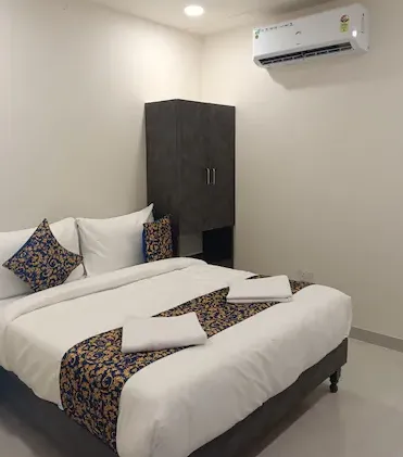 Premium room at Hotel RoyalOcean Prime Jaipur with organized furniture and window light