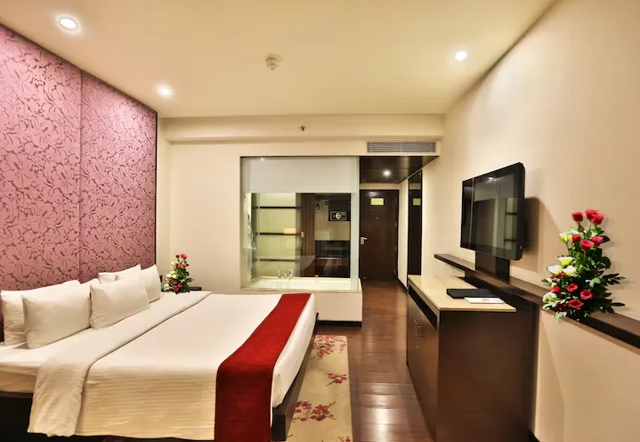 Deluxe room at Hotel Royal Orchid Jaipur featuring modern furnishings and seating space