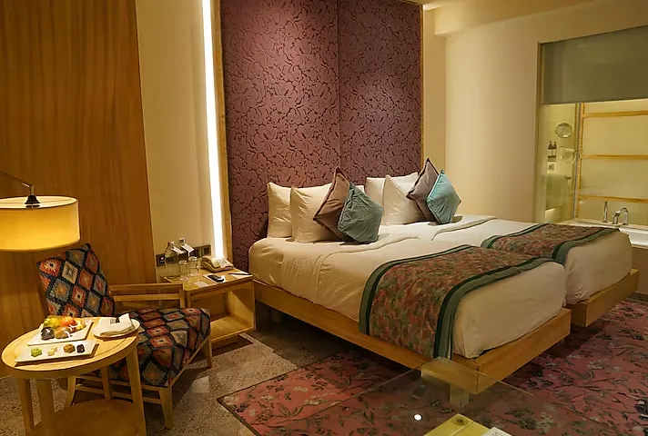 Deluxe room at Hotel Royal Orchid Jaipur featuring modern furnishings and seating space