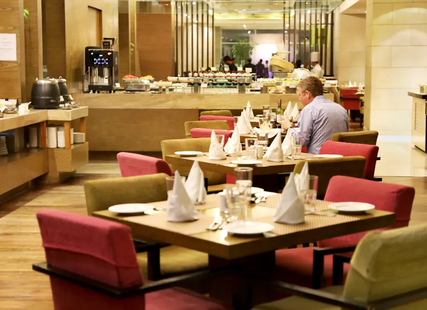 Restaurant at Hotel Royal Orchid Jaipur displaying dining tables and interior setup