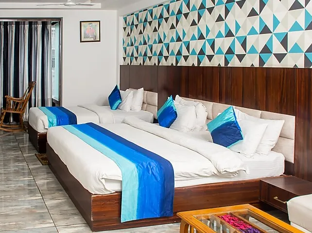 Suite room at Hotel SGT Plaza Varanasi with larger layout and multiple seating areas
