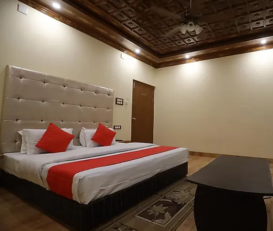 Executive room at Hotel Vijayvargiya Dhani Bikaner showing bed, workspace, and minimal décor