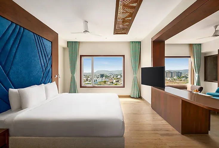 Executive room at Howard Johnson by Wyndham Udaipur featuring work desk and bed arrangement