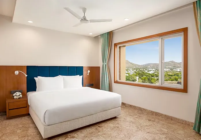 Suite room at Howard Johnson by Wyndham Udaipur with separate seating and sleeping zones