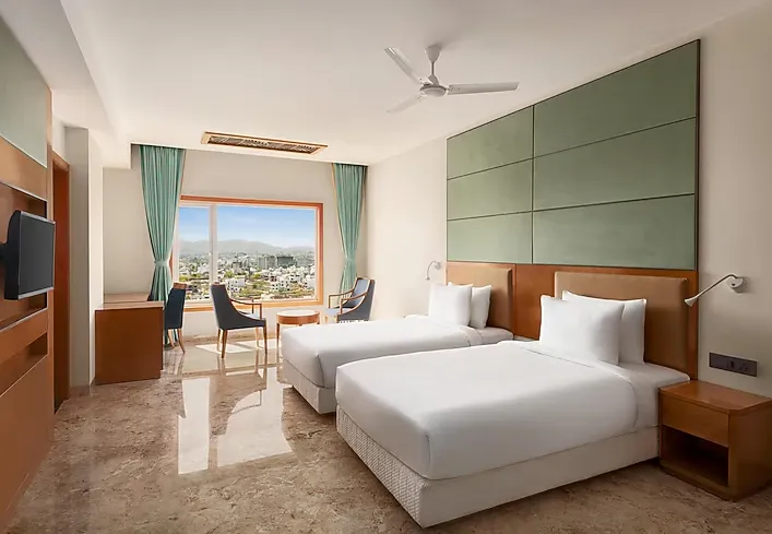 Premium room at Howard Johnson by Wyndham Udaipur featuring modern furnishings and soft interior tones