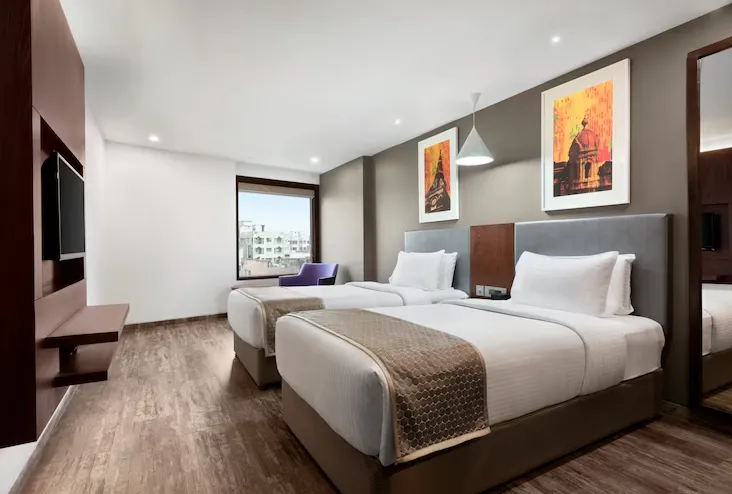 Deluxe room at Howard Johnson by Wyndham, Kolkata Airport featuring spacious layout and work desk