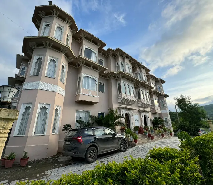 Hotel entrance of Jag Aravali Udaipur with exterior facade, driveway access, and signage