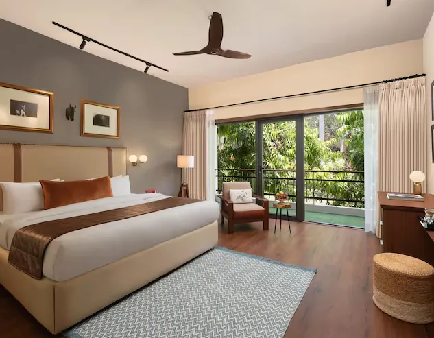 Deluxe room at Modi Estate - AM Hotel Kollection Meerut with enhanced space and seating arrangement