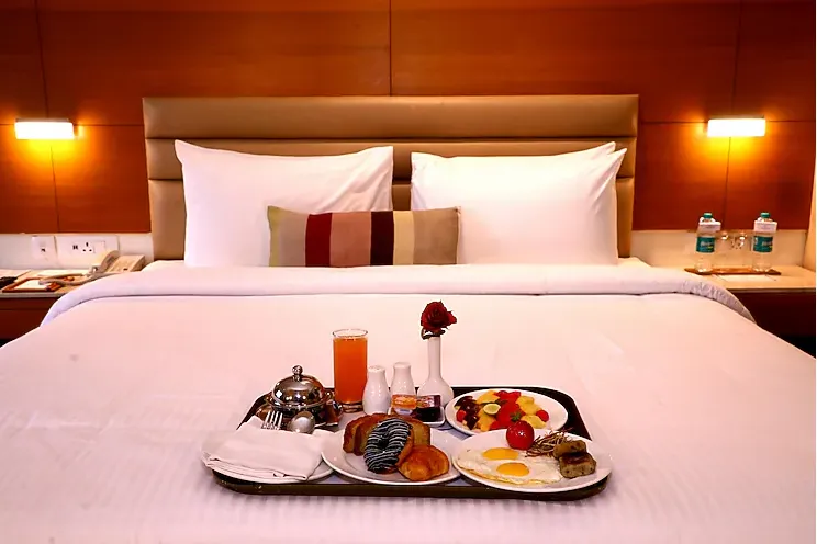 Deluxe room at Nataraj Sarovar Portico-Jhansi Gorakhpur showing extended space and organised furniture layout