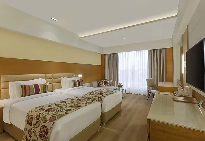 Superior room at Nataraj Sarovar Portico-Jhansi Gorakhpur with comfortable bedding and functional room design