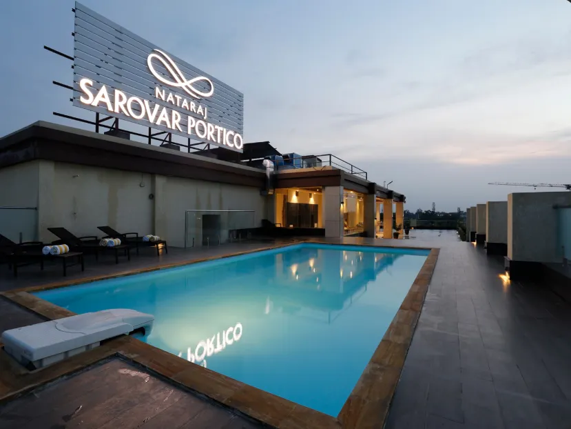 Swimming pool at Nataraj Sarovar Portico-Jhansi Gorakhpur with clean poolside space and water area