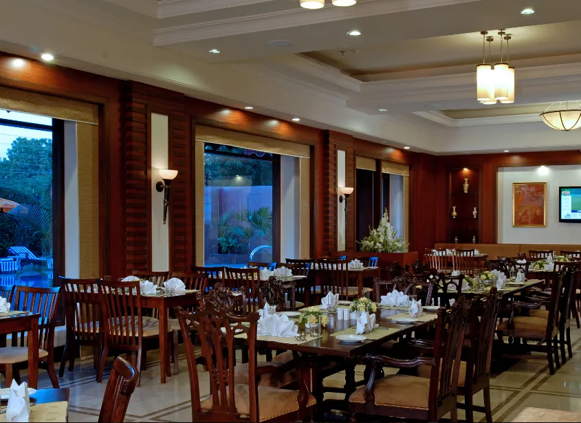Restaurant at Park Plaza Jodhpur showcasing dining tables and interior décor