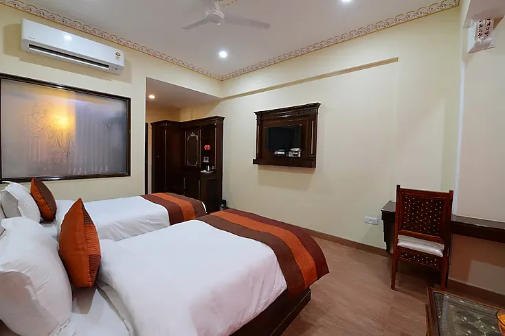 Deluxe room at Hotel Raj Haveli Bikaner with larger sleeping area, heritage décor, and warm lighting