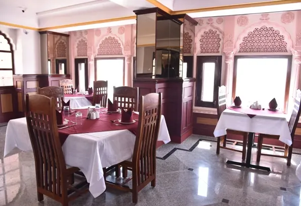 Restaurant at Hotel Raj Haveli Bikaner showing dining tables and heritage-style décor
