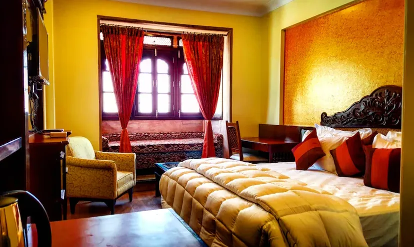 Super Deluxe room at Hotel Raj Haveli Bikaner with larger sleeping area, heritage décor, and warm lighting