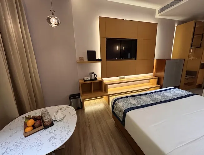 Premium room at Rajawat The Fern - An Ecotel Hotel, Kanpur with neat bedding, work desk, and minimalist interiors