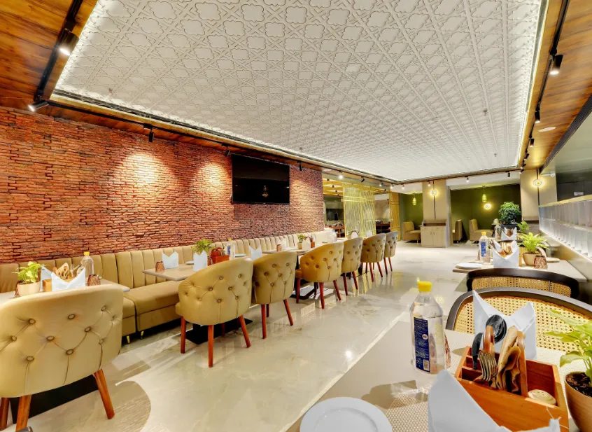 Restaurant at Rajawat The Fern - An Ecotel Hotel, Kanpur with dining tables, chairs, and clean interior setup