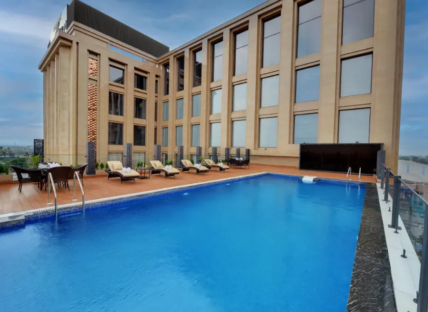 Swimming pool at Rajawat The Fern - An Ecotel Hotel, Kanpur with poolside flooring and water area