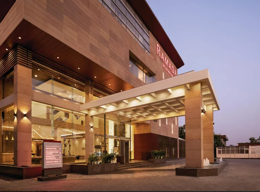 Hotel entrance of Ramada By Wyndham Aligarh GT Road Agra showing branded signage and covered driveway access