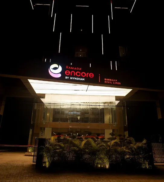 Hotel entrance of Ramada Encore by Wyndham Bareilly Civil Lines displaying the exterior structure, signage, and driveway area