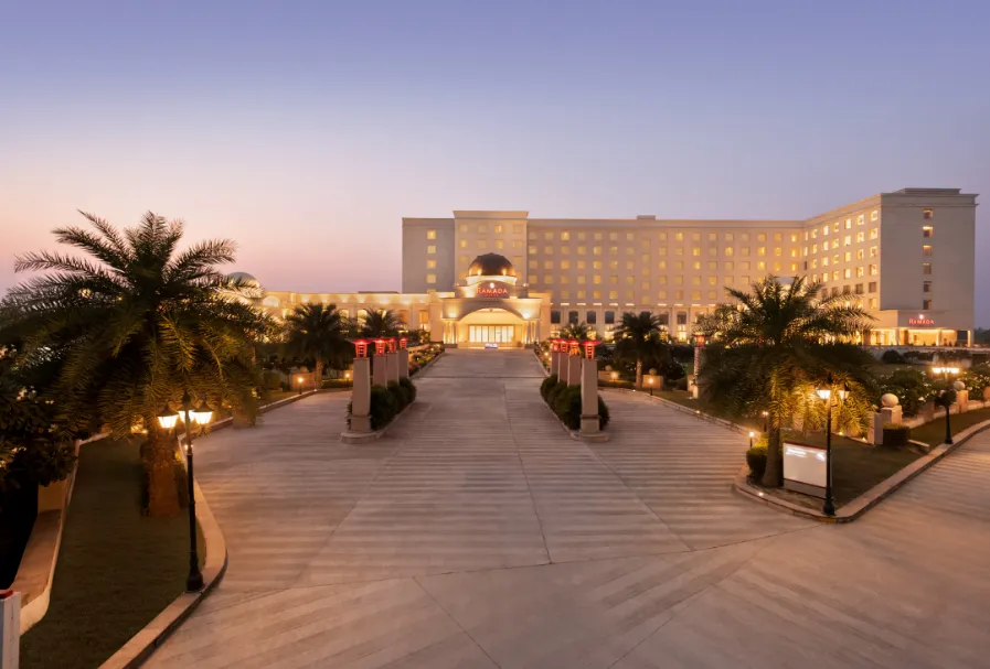Entrance of Ramada Plaza by Wyndham Lucknow displaying exterior structure and driveway access