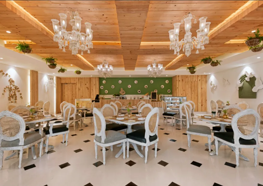 Restaurant at Ramada Plaza by Wyndham Lucknow showing dining tables and interior layout