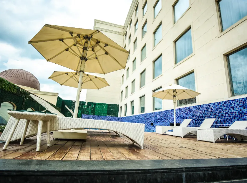 Swimming pool at Ramada Plaza by Wyndham Lucknow with pool deck and surrounding area